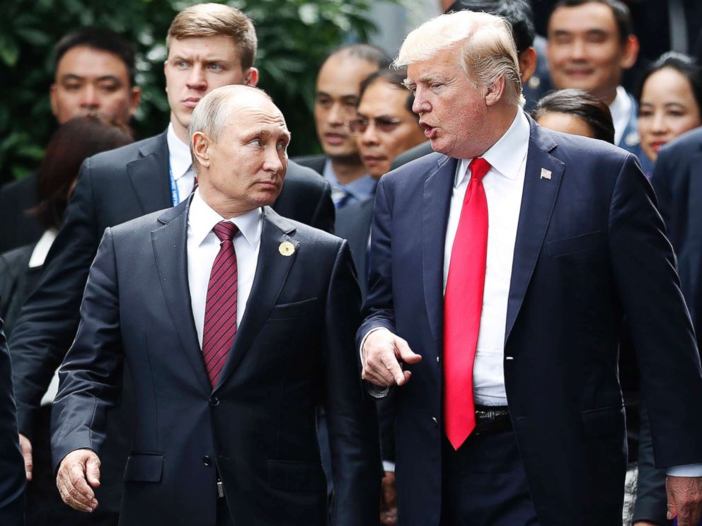 PHOTO: President Donald Trump and Russias President Vladimir Putin talk as Vietnams President Tran Dai Quan, right, looks on during the family photo session at the APEC Summit in Danang, Vietnam, Nov. 11, 2017.