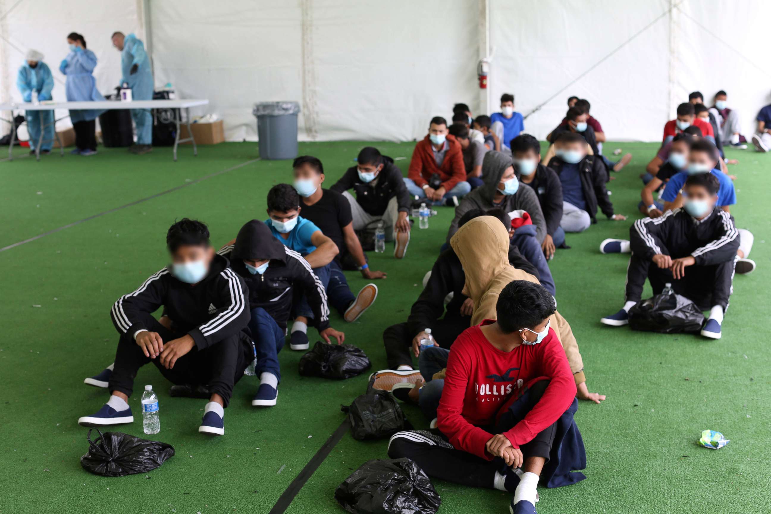 PHOTO: Young migrants wait to be tested for Covid-19 at the Department of Homeland Security holding facility, March 30, 2021, in Donna, Texas.