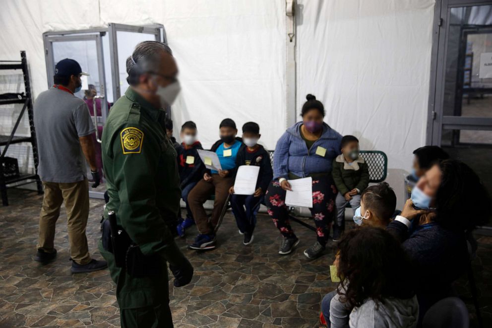 PHOTO: Migrants are processed at the intake area in the Department of Homeland Security holding facility, March 30, 2021 in Donna, Texas.
