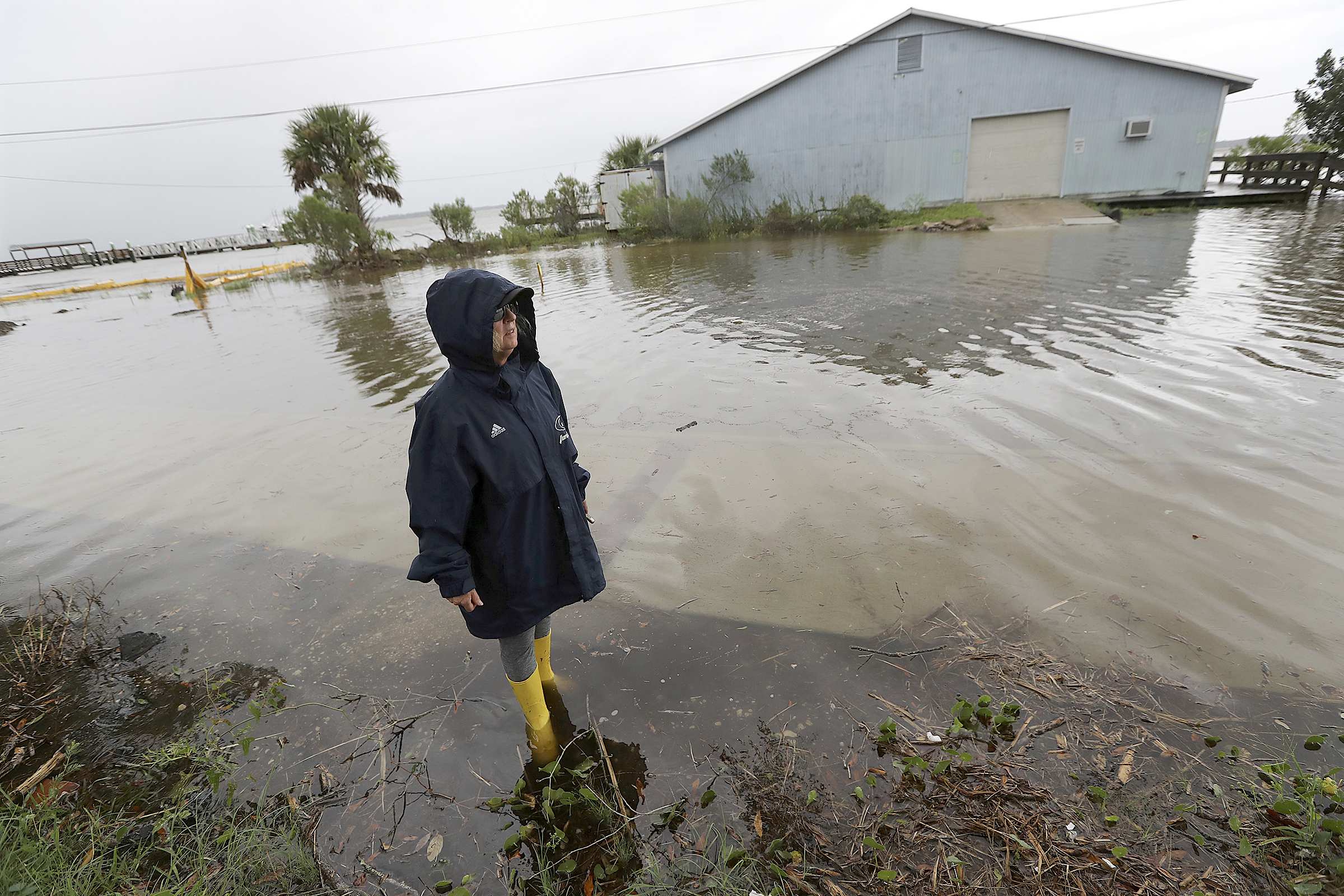 PHOTO: Cheryl Conners looks over flood waters surrounding Langs Marina near her home during Hurricane Dorian, Sept. 4, 2019, in St. Mary's, Ga.