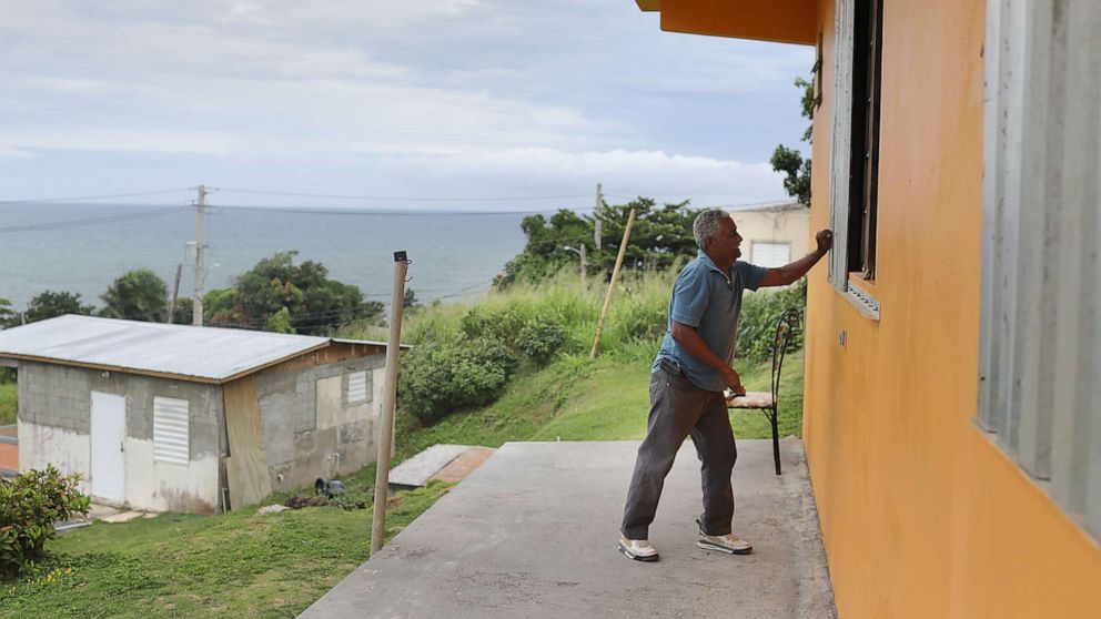PHOTO: Zollo Azea puts shutters over the windows of his home as he prepares for the arrival of Tropical Storm Dorian on Aug. 28, 2019, in Yabucoa, Puerto Rico.