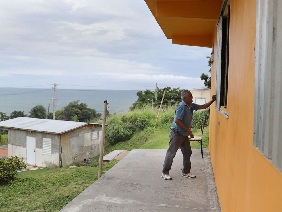 PHOTO: Zollo Azea puts shutters over the windows of his home as he prepares for the arrival of Tropical Storm Dorian on Aug. 28, 2019, in Yabucoa, Puerto Rico.