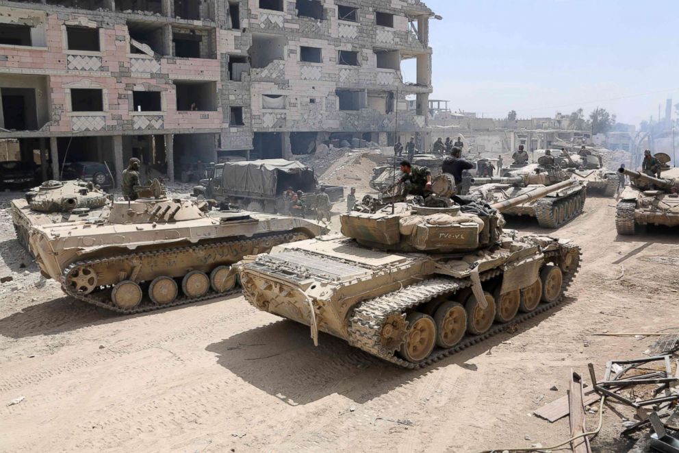 PHOTO: Syrian Army soldiers gathering in an area on the eastern outskirts of Douma, as they continue their fierce offensive to retake the last opposition holdout in Eastern Ghouta, April 8, 2018.