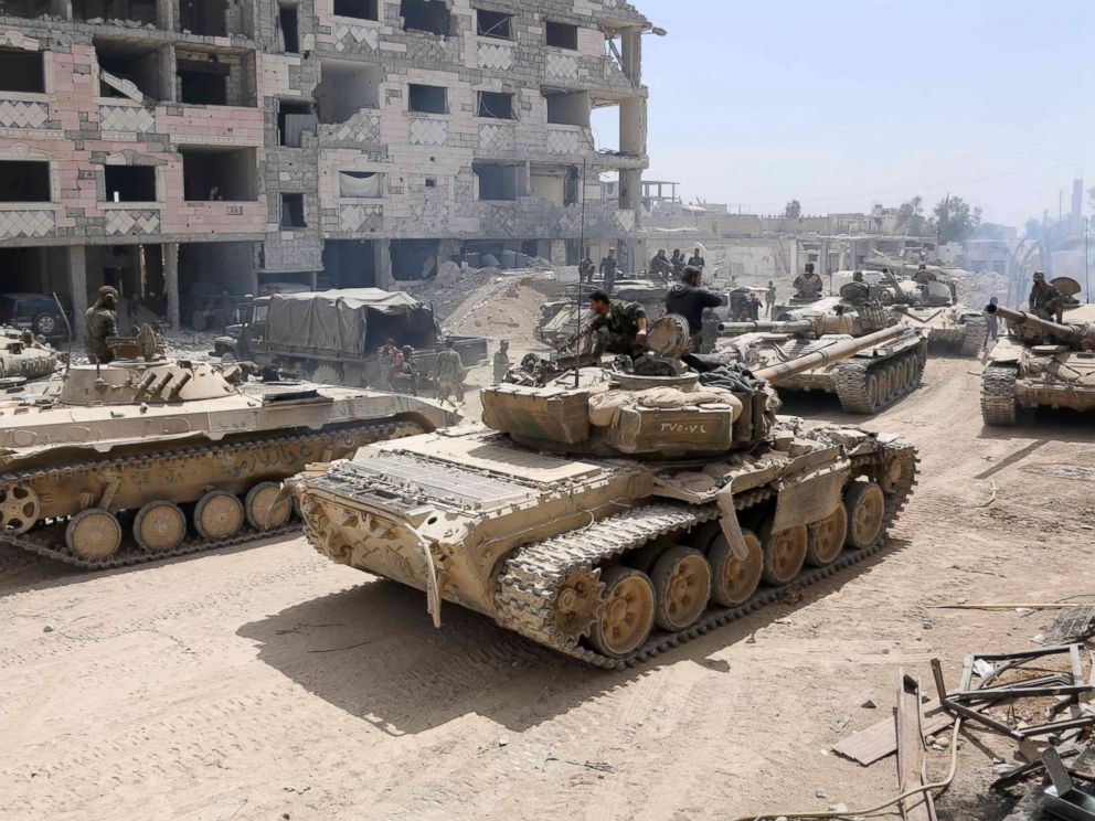 PHOTO: Syrian Army soldiers gathering in an area on the eastern outskirts of Douma, as they continue their fierce offensive to retake the last opposition holdout in Eastern Ghouta, April 8, 2018.