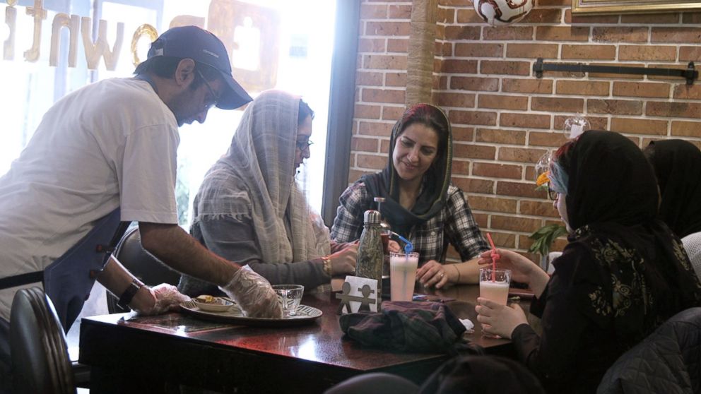 PHOTO: Staff member Mehdi Khakian serves customers at the Downtism Cafe, in Tehran, Iran, on Dec. 11, 2018.