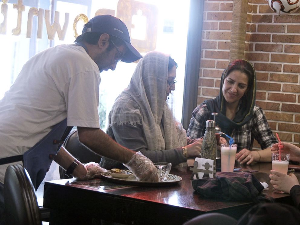 PHOTO: Staff member Mehdi Khakian serves customers at the Downtism Cafe, in Tehran, Iran, on Dec. 11, 2018.