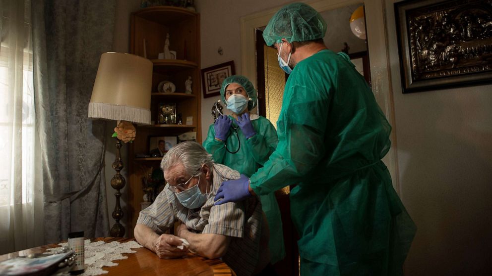 PHOTO: A nurse provides cares to a patient during a house call visit in Barcelona, Catalonia, north eastern Spain, May 23, 2020. 