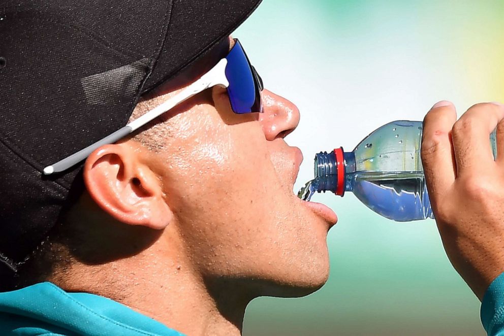 PHOTO: New Zealand's Ross Taylor drinks water as he fields on the boundary line during the first one-day international cricket match between Australian and New Zealand in Sydney on March 13, 2020.
