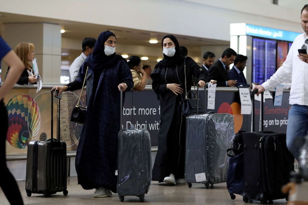 FILE PHOTO: Travelers wear masks as they arrive at Dubai International Airport, after the United Arab Emirates' Ministry of Health and Community Prevention confirmed the country's first case of coronavirus, Jan. 29, 2020.