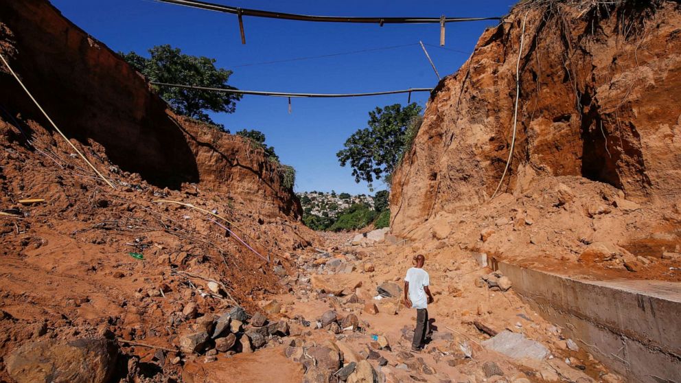 PHOTO: A man walks below a bridge which was destroyed after heavy rains caused flooding in Ntuzuma near Durban, South Africa, April 20, 2022.