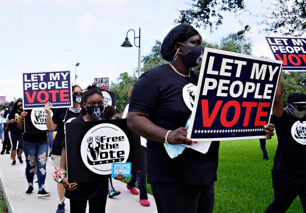 PHOTO: Supporters of restoring Florida felons' voting rights march to an early voting precinct, Oct. 24, 2020, in Fort Lauderdale, Fla.