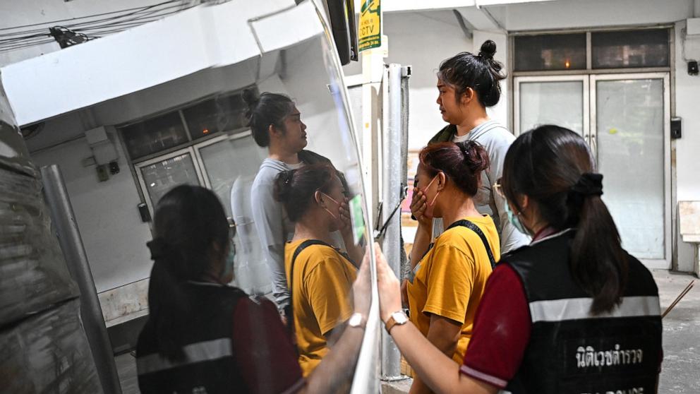 PHOTO: Family members react as the remains of a victim from the under-construction building collapse site are loaded into an ambulance at the Police Hospital in Bangkok on March 31, 2025.