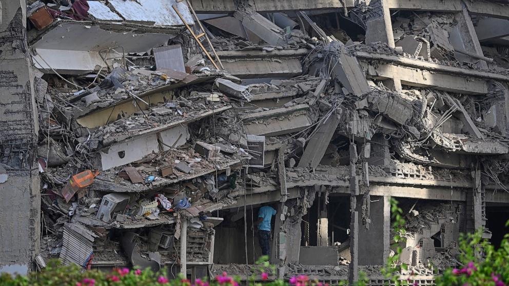 A man inspects a collapsed apartment building following an earthquake in Catia La Mar, La Guaira state, 30km north-west of Caracas, June 25, 2026. VENEZUELA-EARTHQUAKE