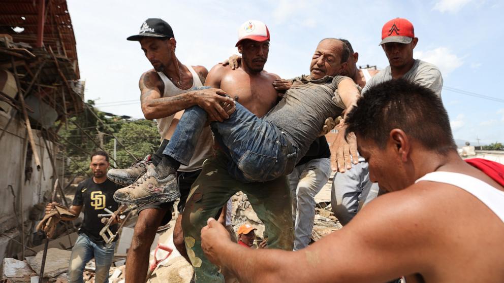 PHOTO: Neighbors carry a man rescued from the rubble of a collapsed building a day after earthquakes struck La Guaira, Venezuela, June 25, 2026. 