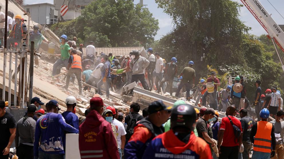 PHOTO: People search for casualties amid the rubble of a collapsed building, in the aftermath of earthquakes in Caracas, Venezuela, June 25, 2026. 