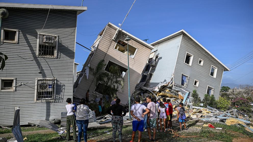 PHOTO: People stand before damaged homes following an earthquake in Catia La Mar, La Guaira state, 30km north-west of Caracas, June 25, 2026.