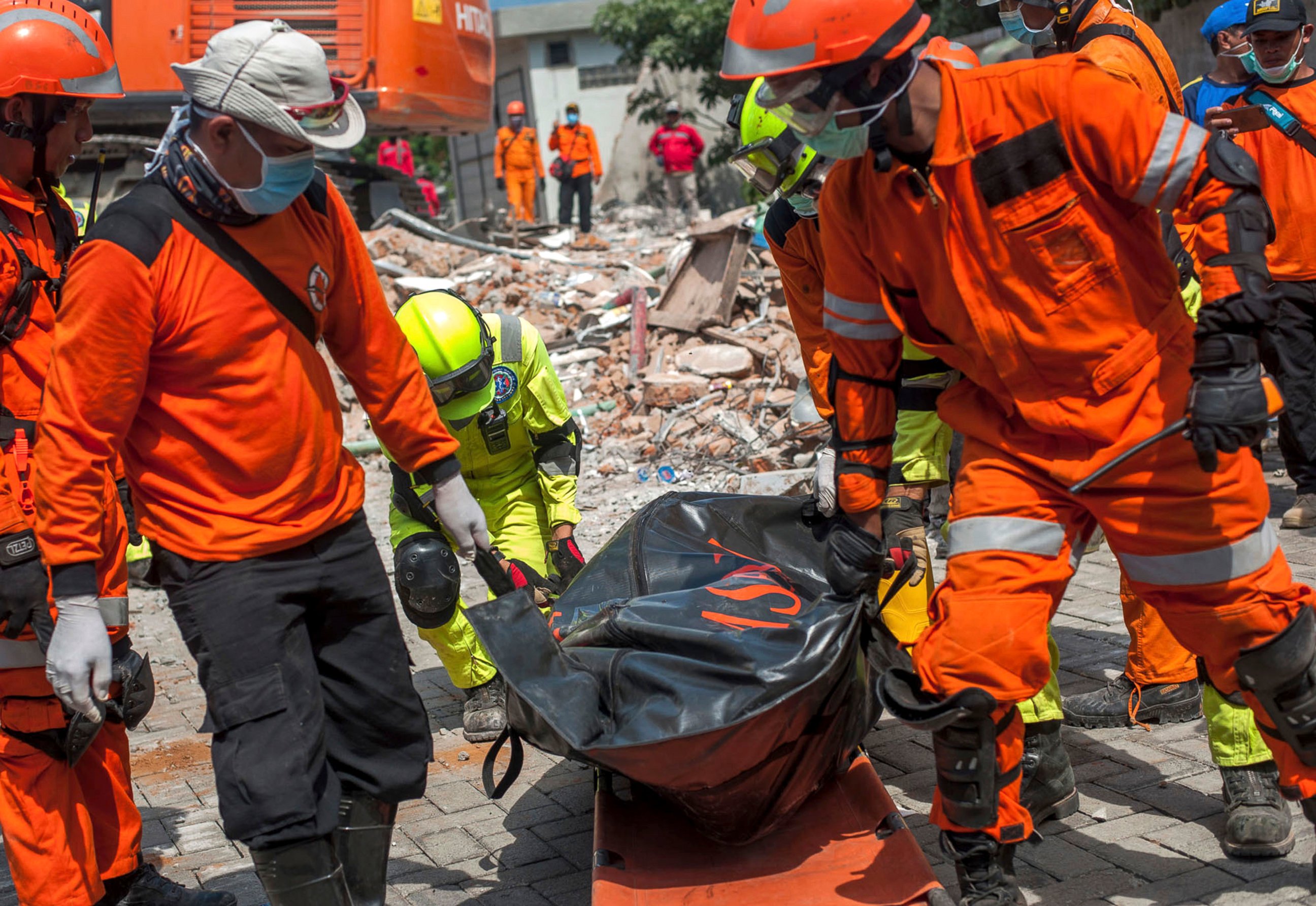 PHOTO: Rescuers recover the body of an earthquake victim from the ruins of the collapsed Roa Roa Hotel in Palu, Central Sulawesi, Indonesia, Tuesday, Oct. 2, 2018. 