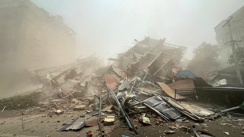 PHOTO: People inspect the debris of a collapsed building in Mandalay on March 28, 2025, after an earthquake.