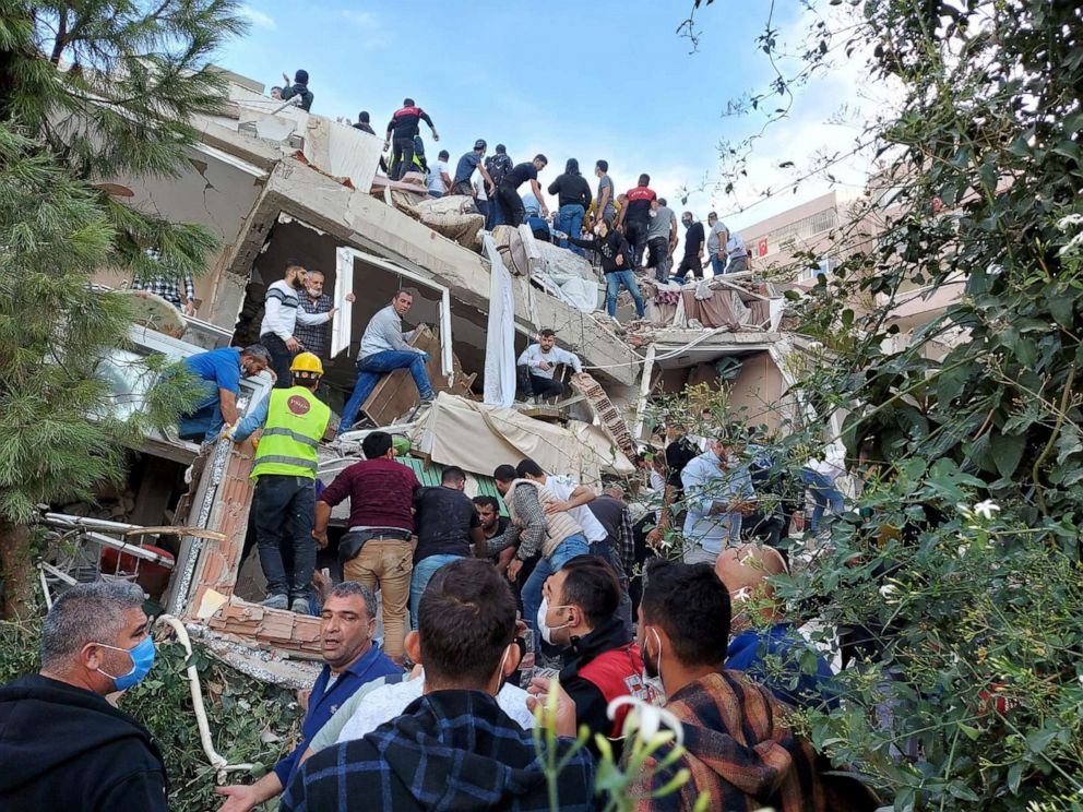 PHOTO: Locals and officials search for survivors at a collapsed building after a strong earthquake struck the Aegean Sea and was felt in both Greece and Turkey, where some buildings collapsed in the coastal province of Izmir, Turkey, Oct. 30, 2020.