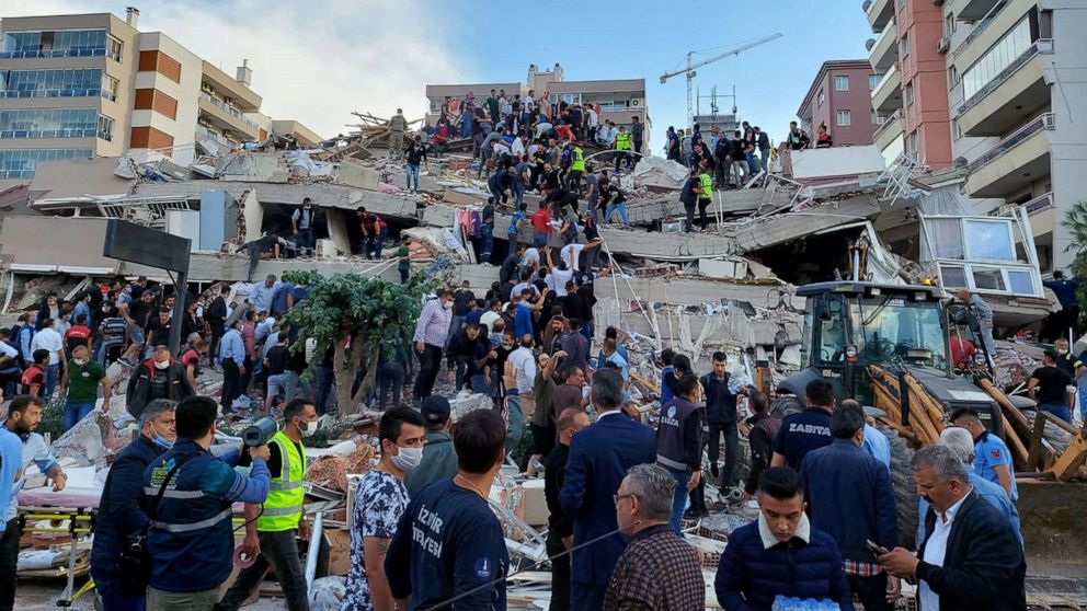 PHOTO: Locals and officials search for survivors at a collapsed building after a strong earthquake struck the Aegean Sea and was felt in both Greece and Turkey, where some buildings collapsed in the coastal province of Izmir, Turkey, Oct. 30, 2020.