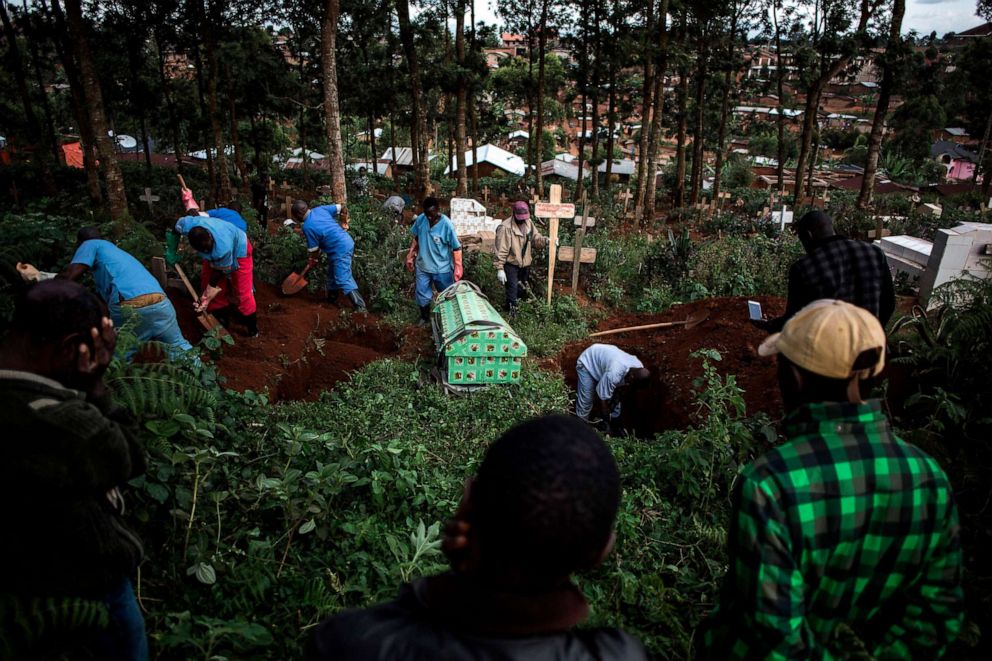 PHOTO:Family members react as they watch a victim of the Ebola virus being buried, May 16, 2019, in Butembo in Democratic Republic of Congo.