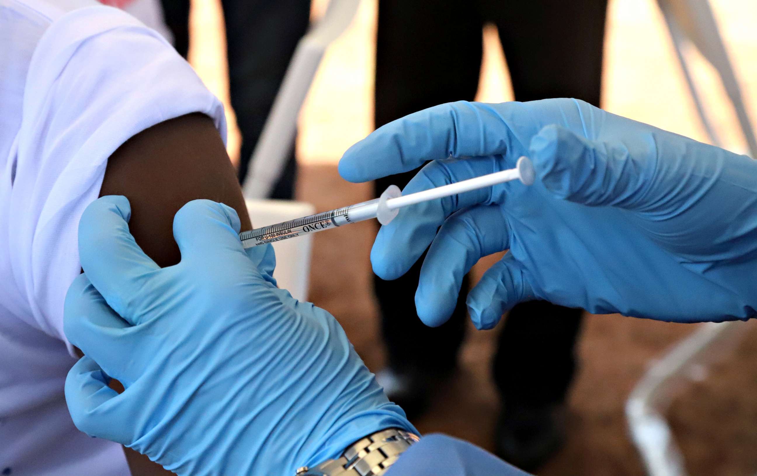 PHOTO: A World Health Organization (WHO) worker administers a vaccination during the launch of a campaign aimed at beating an outbreak of Ebola in the port city of Mbandaka, Democratic Republic of Congo on May 21, 2018. 