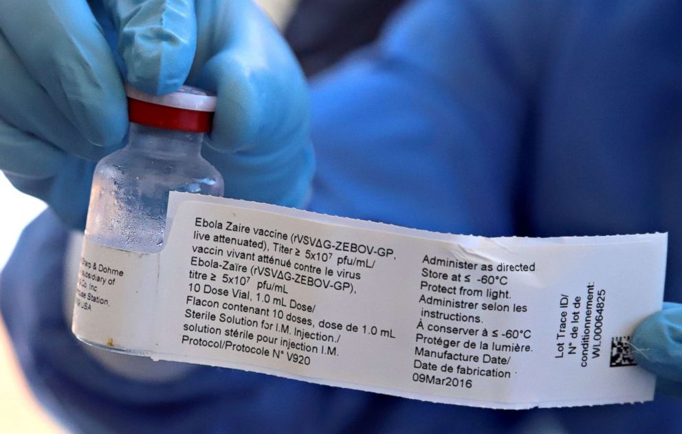 PHOTO: A World Health Organization (WHO) worker prepares to administer a vaccine during the launch of a campaign aimed at beating an outbreak of Ebola in the port city of Mbandaka, Democratic Republic of Congo on May 21, 2018. 