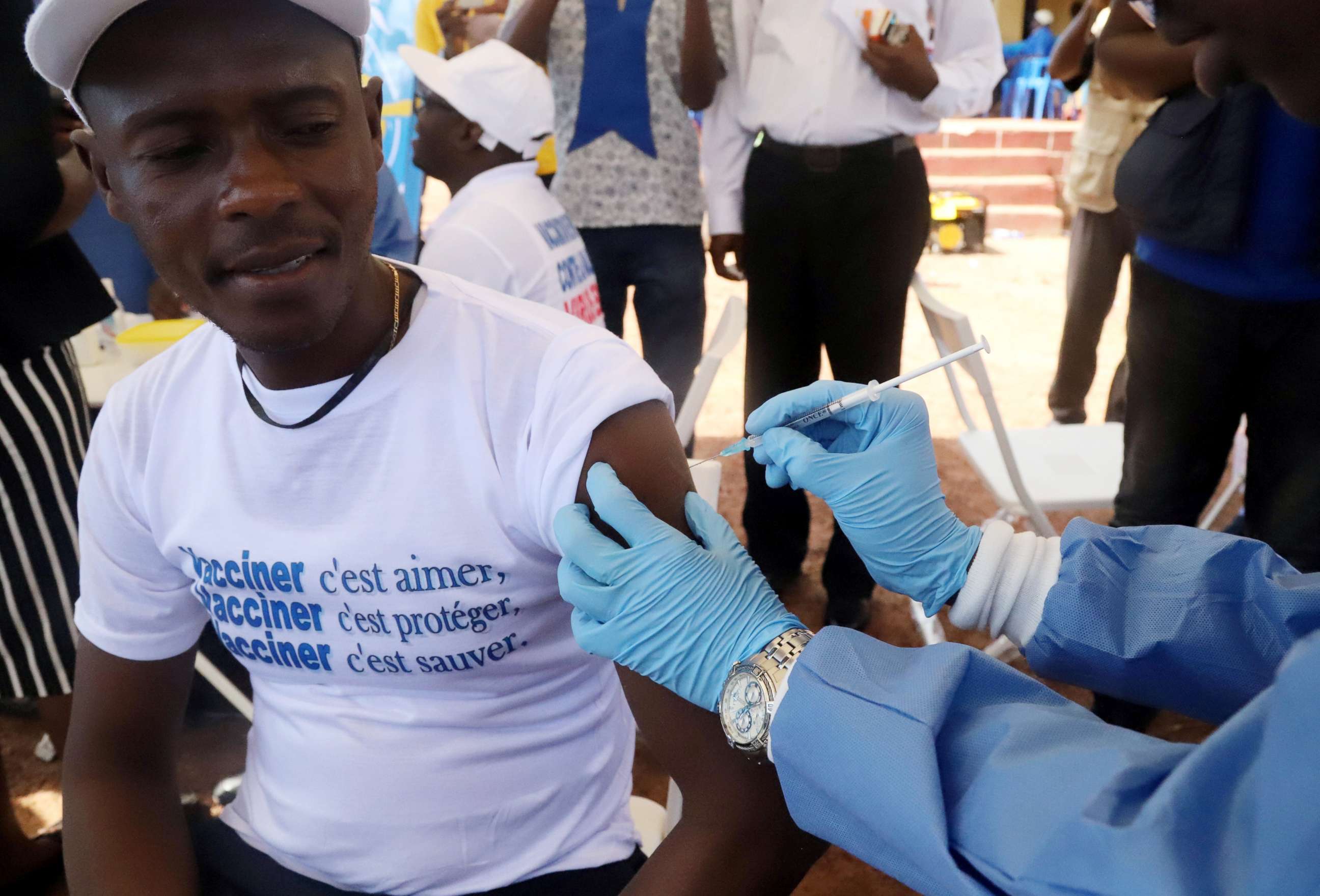 PHOTO: A World Health Organization (WHO) worker administers a vaccine during the launch of a campaign aimed at beating an outbreak of Ebola in the port city of Mbandaka, Democratic Republic of Congo on May 21, 2018. 