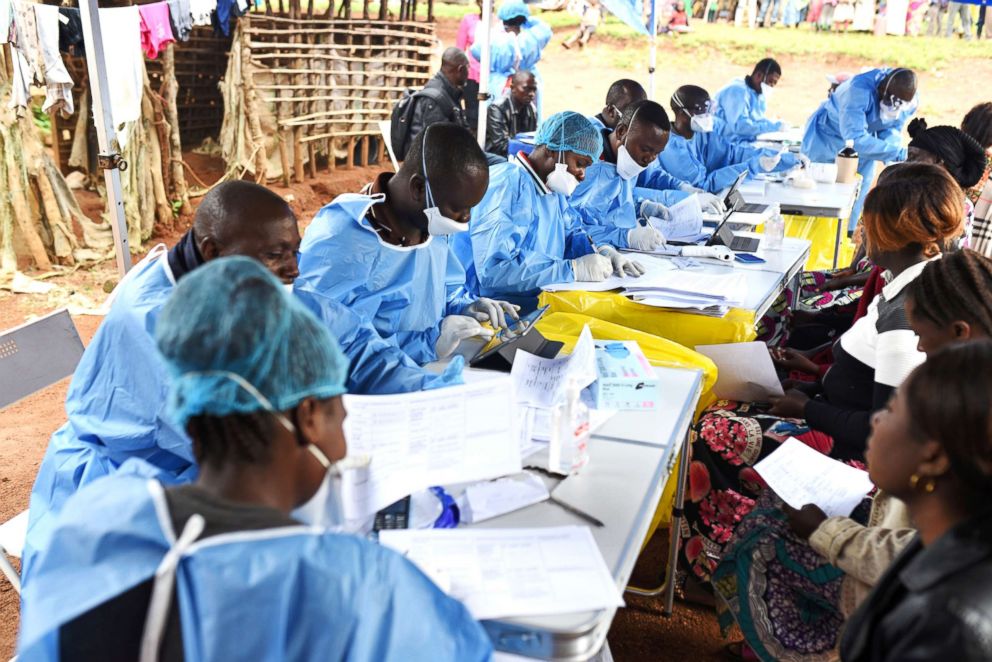 PHOTO: Congolese health workers register people and take their temperatures before they are vaccinated against Ebola in the village of Mangina in North Kivu province of the Democratic Republic of Congo, Aug. 18, 2018.