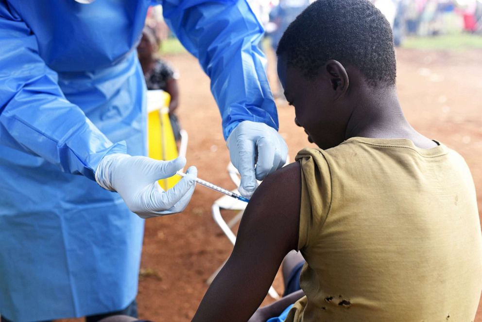 PHOTO: A Congolese health worker administers Ebola vaccine to a boy who had contact with an Ebola sufferer in the village of Mangina in North Kivu province of the Democratic Republic of Congo, Aug.18, 2018.