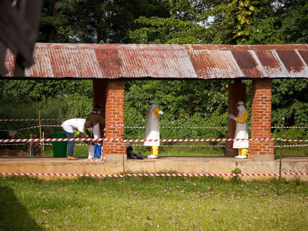 PHOTO: A handout photo made available by UNICEF shows health workers being sprayed with chlorine after leaving the isolation ward at Bikoro Hospital, in Bikoro, The Democratic Republic Of The Congo, May 12, 2018.