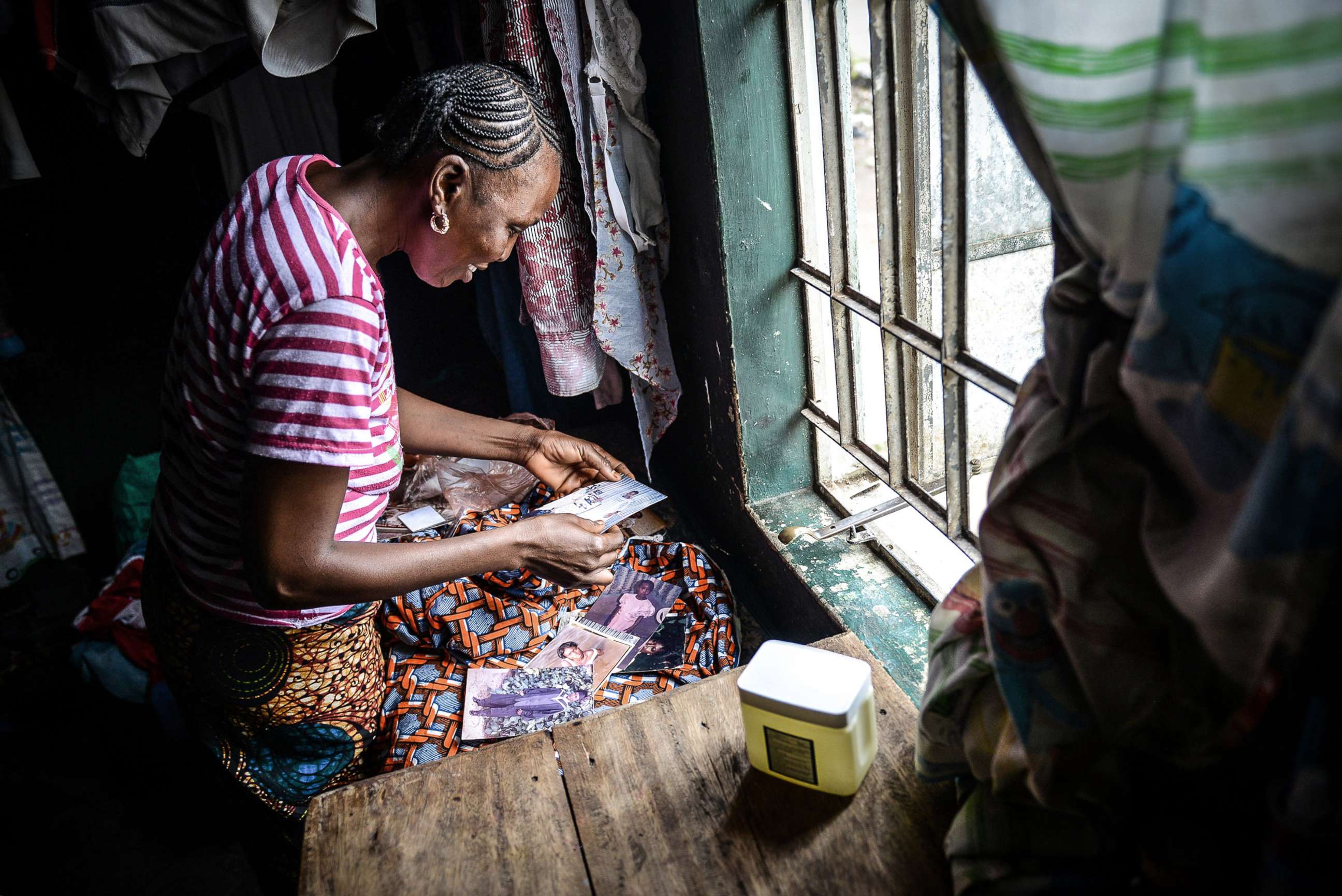 PHOTO: Rigiatu Kamara, 38, who has recovered from the Ebola virus disease smiles as she looks at the photos from her youth in Kenema, Sierra Leone, on Aug. 26, 2014.