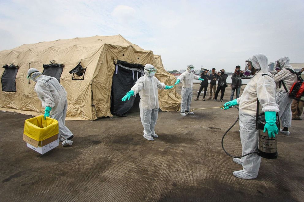 PHOTO: Health care workers go through an emergency simulation Ebola exercise at the Tanjung Emas port on Dec. 04, 2014 in Semarang, Central Java, Indonesia.