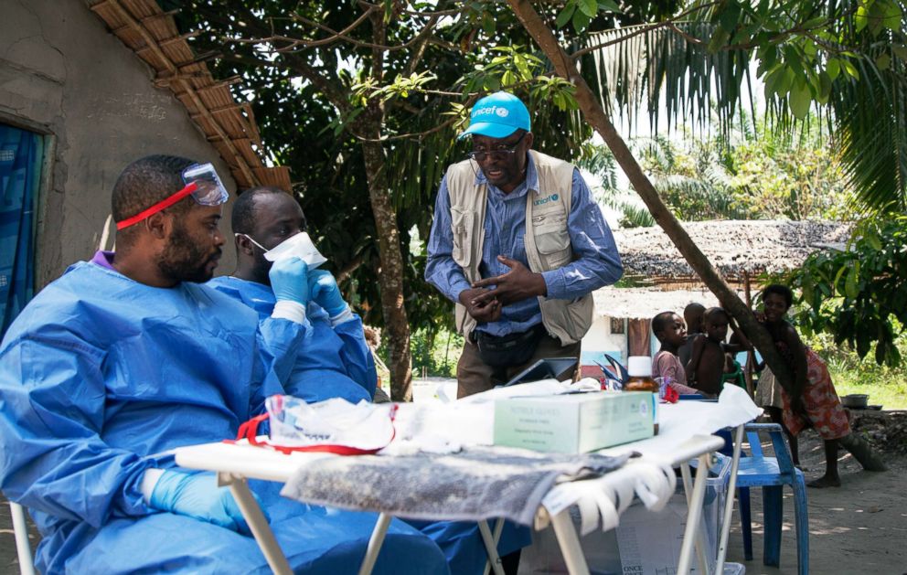 PHOTO: In this photo taken, May 25, 2018, UNICEF staffer Jean Claude Nzengu, center, talks with members of an Ebola vaccination team as they prepare to administer the vaccine in an Ebola-affected community in the north-western city of Mbandaka, in Congo.