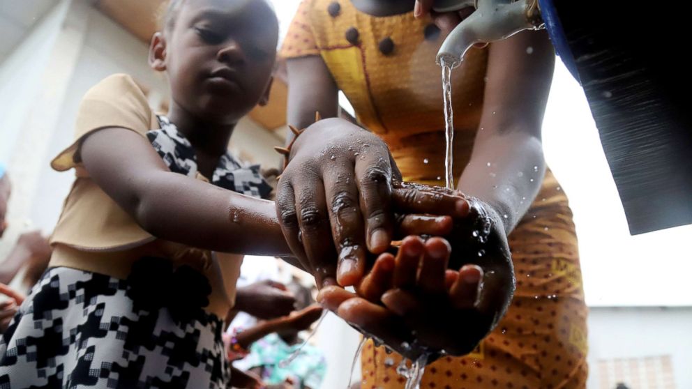 PHOTO: A Congolese child washes her hands as a preventive measure against Ebola at the Church of Christ in Mbandaka, Democratic Republic of Congo, May 20, 2018.