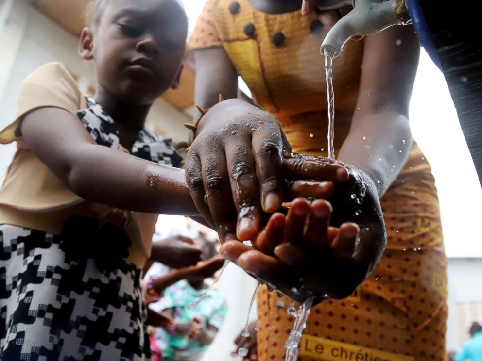 PHOTO: A Congolese child washes her hands as a preventive measure against Ebola at the Church of Christ in Mbandaka, Democratic Republic of Congo, May 20, 2018.