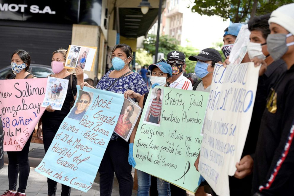 PHOTO: Families looking for their deceased loved ones who have been lost or misidentified during the outbreak of the Covid-19 pandemic hold signs during a protest in Guayaquil, Ecuador, May 20, 2020. 