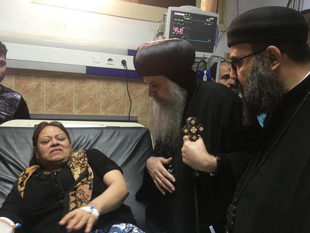 PHOTO: Egypt's Coptic priest Agathon speaks to a woman who was wounded when gunmen attacked a bus carrying Coptic Christians, at the Sheikh Fadel hospital in Beni Mazar on November 2, 2018.