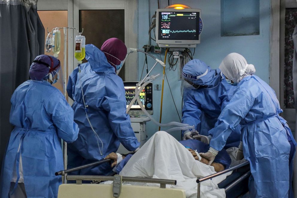 PHOTO: Doctor Saleh Alhosseiny (2nd R) and nurses, adjust an oxygen mask to a Covid-19 patient inside the Intensive Care Unit of Heliopolis hospital, which is currently serving as an isolation hospital for Coronavirus (COVID-19) patients, April 26, 2021.