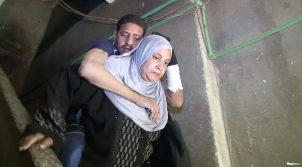 PHOTO: Heba Ragab carried her sick husband, Khaled al-Badawi, to vote in the Egyptian presidential election.