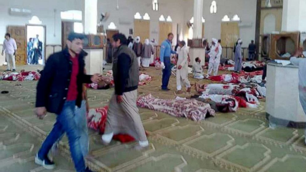 PHOTO: People stand over  bodies of worshipers killed in attack on mosque in the northern city of Arish, Sinai Peninsula, Egypt, Nov. 24, 2017.