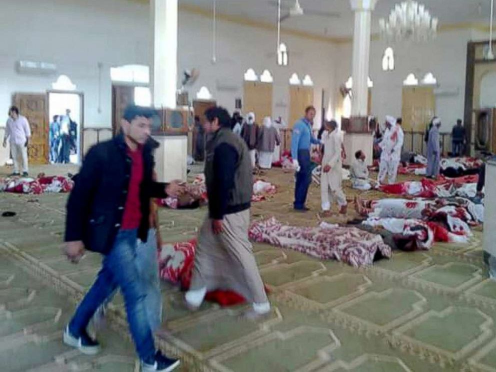 PHOTO: People stand over  bodies of worshipers killed in attack on mosque in the northern city of Arish, Sinai Peninsula, Egypt, Nov. 24, 2017.