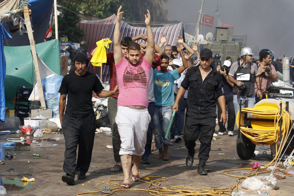 PHOTO: Egyptian security forces escort detained supporters of Egypt's ousted president Mohamed Morsi during an operation to dismantle a huge pro-Islamists protest camp near Rabaa al-Adawiya mosque in Cairo, Aug. 14, 2013.