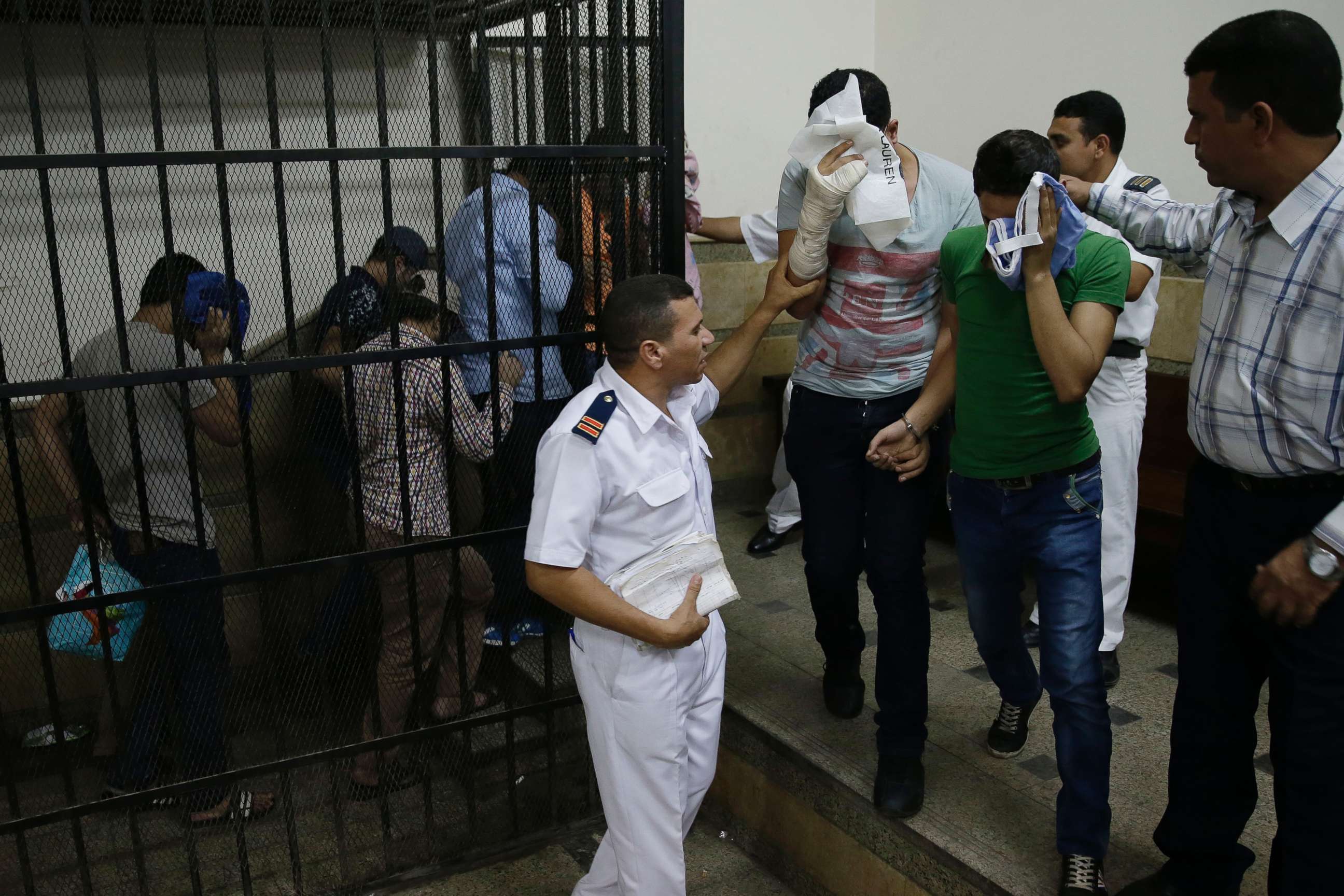 PHOTO: Eight Egyptian men convicted for "inciting debauchery" following their appearance in a video of an alleged same-sex wedding party on a Nile boat leave the defendant's cage in a courtroom in Cairo, Egypt, Nov. 1, 2014. 