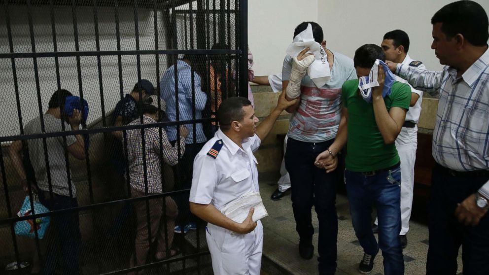 PHOTO: Eight Egyptian men convicted for "inciting debauchery" following their appearance in a video of an alleged same-sex wedding party on a Nile boat leave the defendant's cage in a courtroom in Cairo, Egypt, Nov. 1, 2014. 