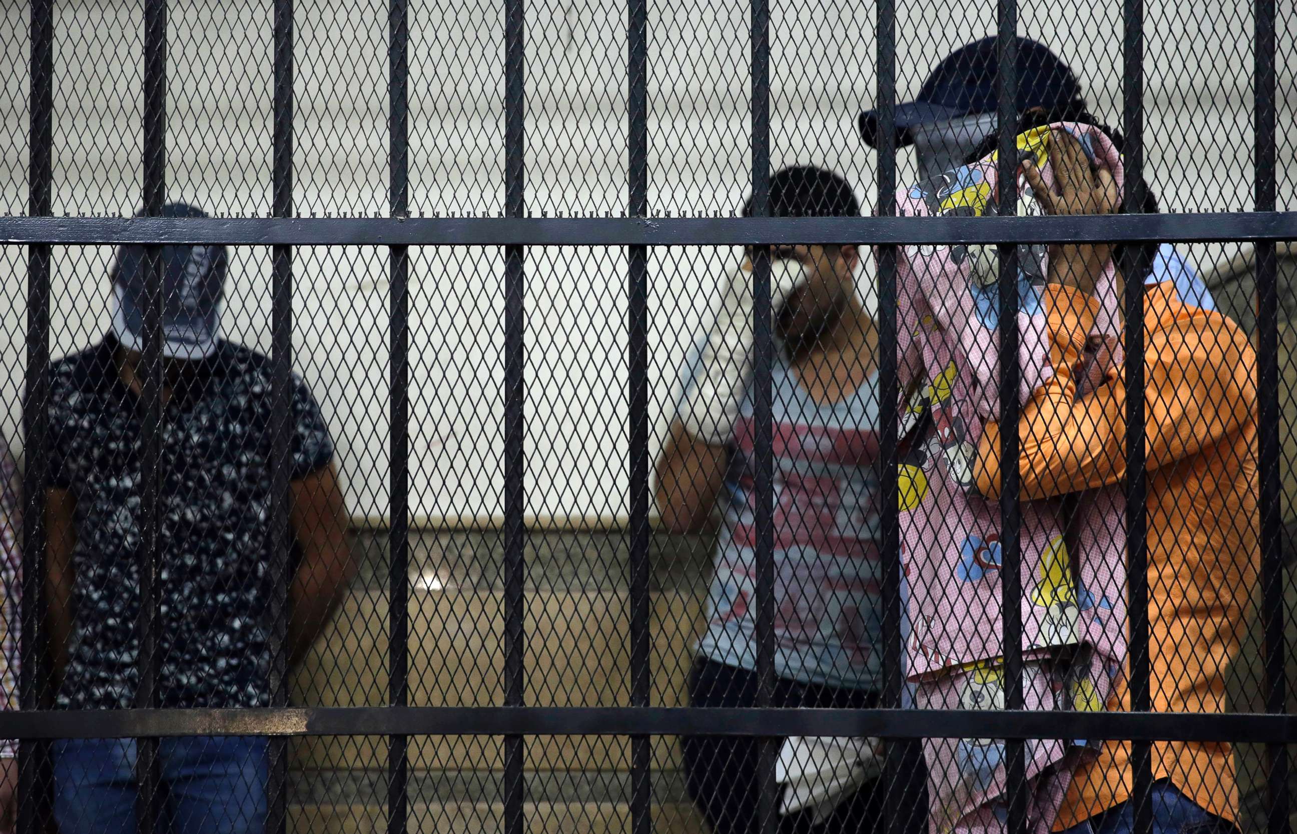 PHOTO: Eight Egyptian men convicted for "inciting debauchery" following their appearance in a video of an alleged same-sex wedding party on a Nile boat cover their faces in the defendant's cage in a courtroom in Cairo, Egypt, Nov. 1, 2014. 