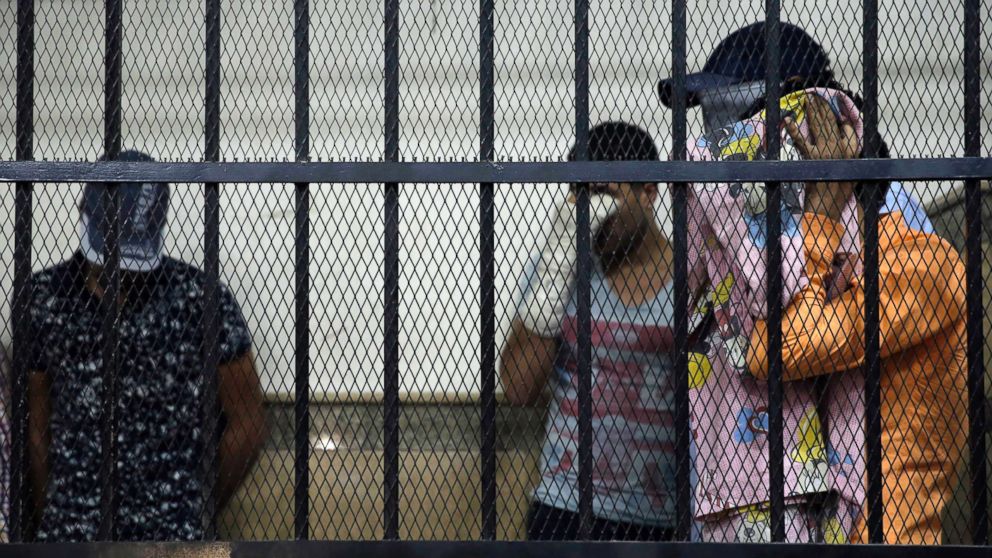 PHOTO: Eight Egyptian men convicted for "inciting debauchery" following their appearance in a video of an alleged same-sex wedding party on a Nile boat cover their faces in the defendant's cage in a courtroom in Cairo, Egypt, Nov. 1, 2014. 