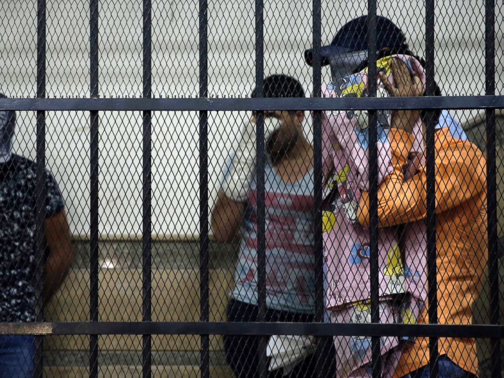 PHOTO: Eight Egyptian men convicted for inciting debauchery following their appearance in a video of an alleged same-sex wedding party on a Nile boat cover their faces in the defendants cage in a courtroom in Cairo, Egypt, Nov. 1, 2014.