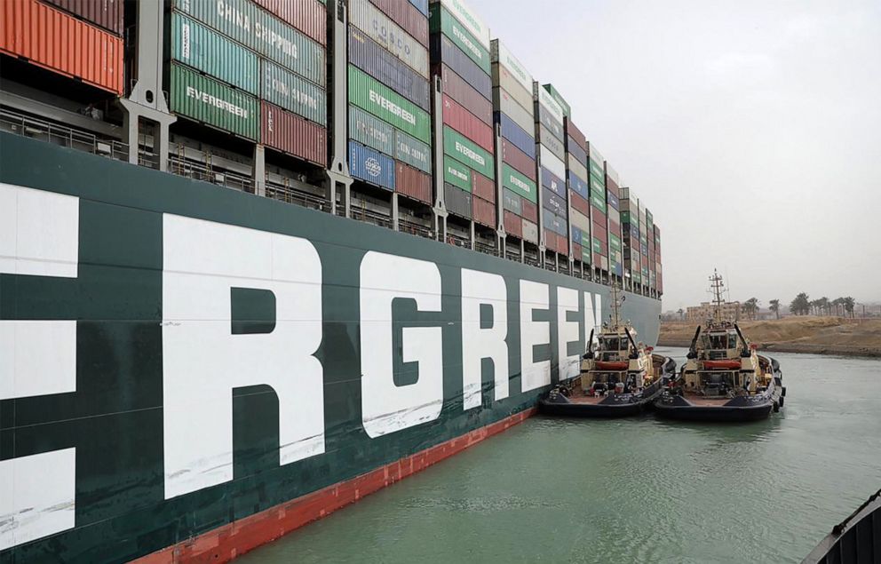 PHOTO: A handout picture released by the Suez Canal Authority on March 25, 2021 shows Egyptian tug boats trying to free Taiwan-owned MV Ever Given (Evergreen.)