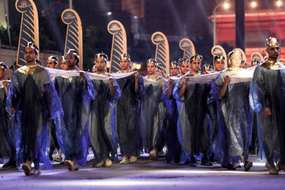 PHOTO: Performers dressed in ancient Egyptian costume march at the start of the parade of 22 ancient Egyptian royal mummies departing from the Egyptian Museum in Cairo's Tahrir Square on April 3, 2021.